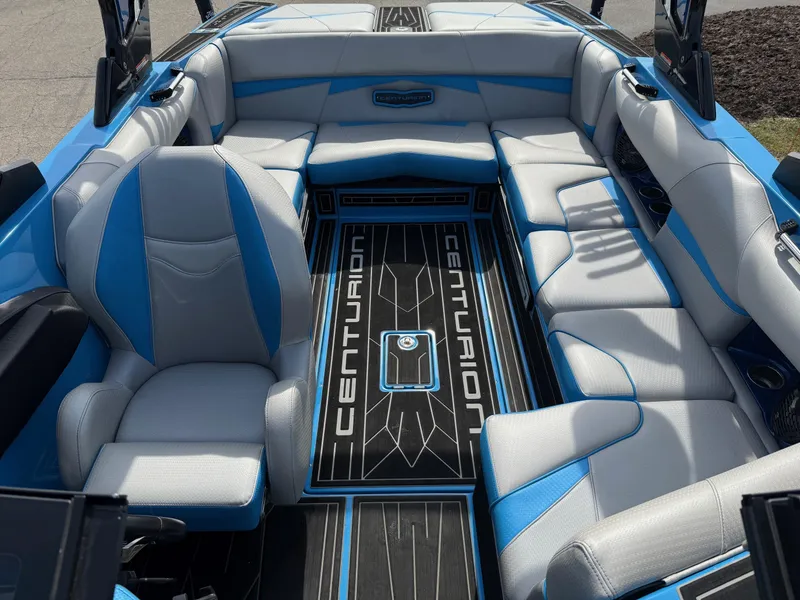 Slide: The Image of 2022 Centurion Fi23 boat interior with blue and white seating and branded flooring. - 7