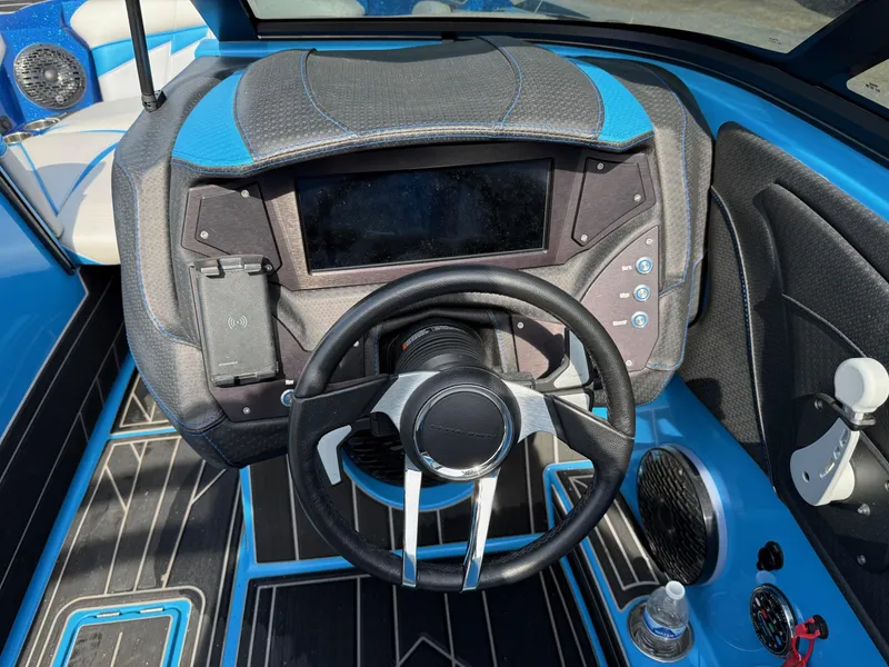 Slide: The Image of 2022 Centurion Fi23 boat dashboard with steering wheel and control panel. - 9