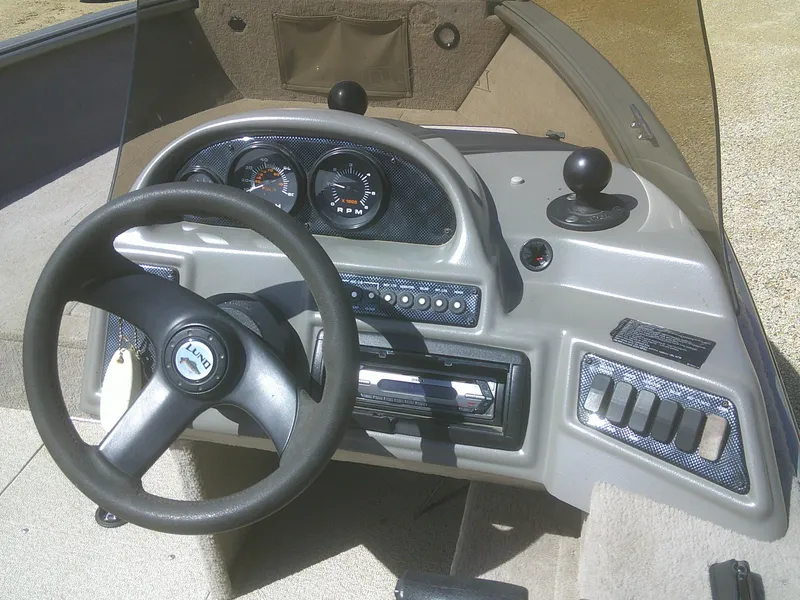 Slide: The Image of 2006 Lund 1600 Explorer SS dashboard with steering wheel and instrument panel. - 11