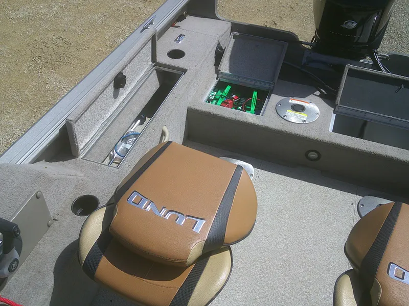 Slide: The Image of 2006 Lund 1600 Explorer SS boat interior with storage compartments and seating. - 15