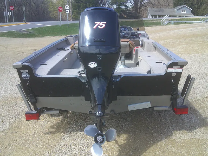 Slide: The Image of 2006 Lund 1600 Explorer SS boat with 75 HP outboard motor, parked on gravel. - 16