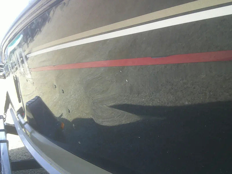 Slide: The Image of Side view of a 2006 Lund 1600 Explorer SS boat with red and white stripes. - 4