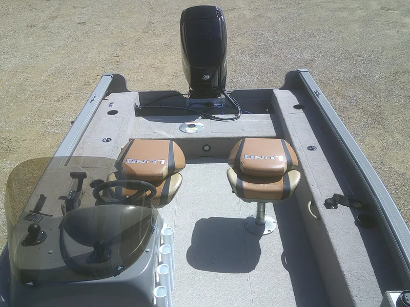 Slide: The Image of 2006 Lund 1600 Explorer SS boat interior with two seats and steering console. - 9