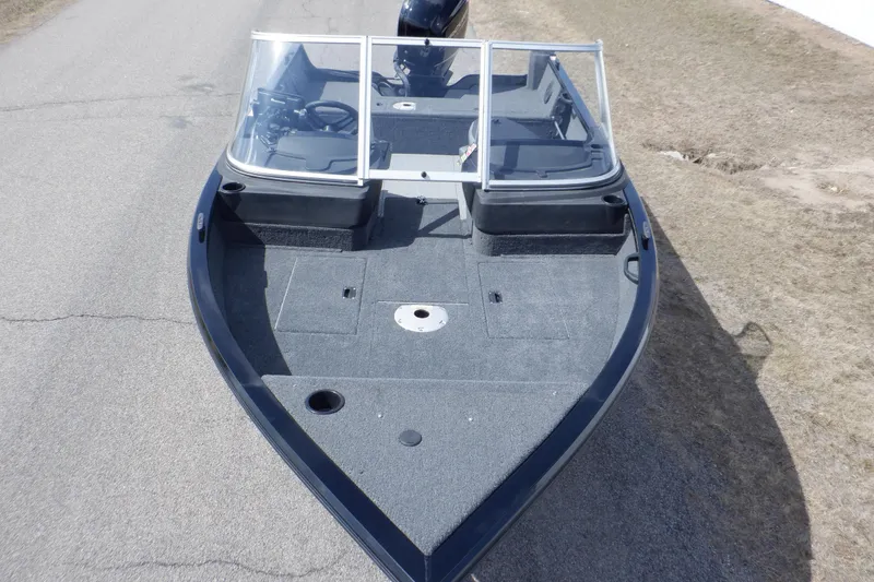 Slide: The Image of 2023 Crestliner 1650 Fish Hawk SE WT boat, top view, on a paved surface. - 11