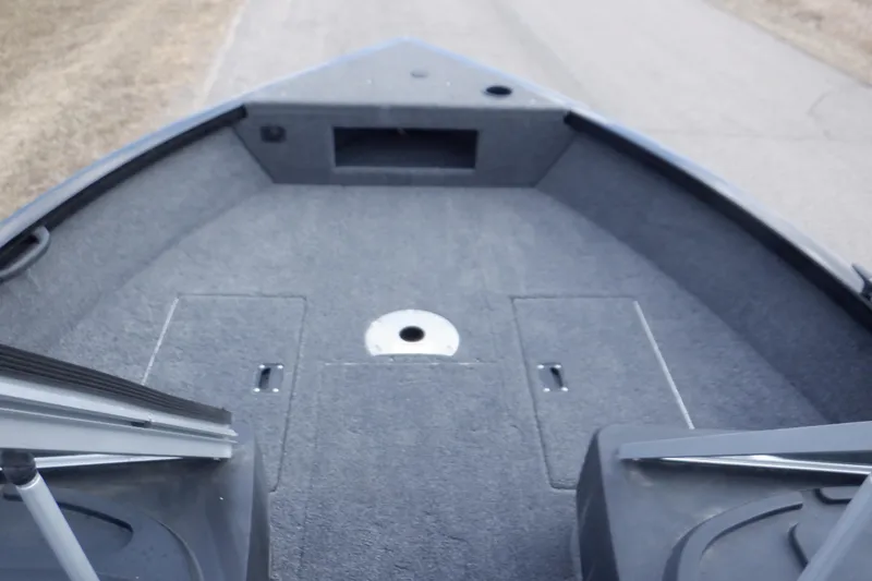 Slide: The Image of 2023 Crestliner 1650 Fish Hawk SE WT boat interior with carpeted deck and storage compartments. - 20