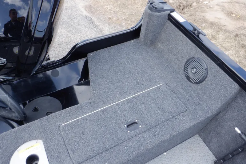 Slide: The Image of 2023 Crestliner 1650 Fish Hawk SE WT boat interior with carpeted deck and storage compartment. - 30