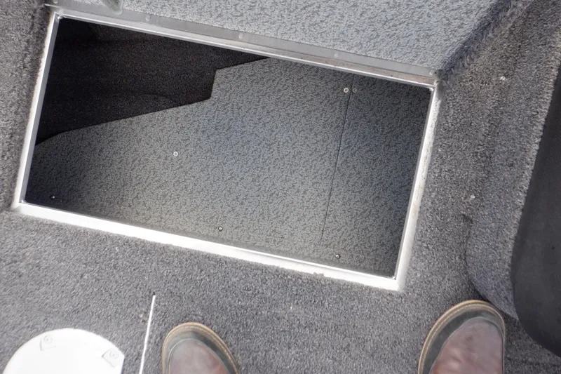 Slide: The Image of 2023 Crestliner 1650 Fish Hawk SE WT boat storage compartment with carpeted interior. - 34