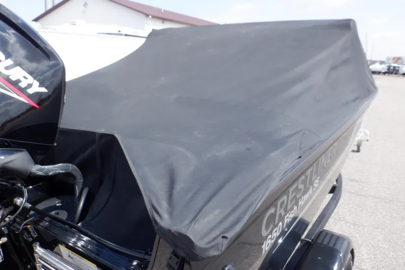Slide: The Image of 2023 Crestliner 1650 Fish Hawk SE WT boat with cover, featuring Mercury engine. - 43