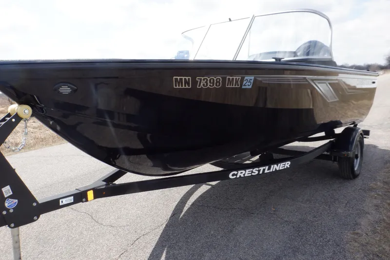 Slide: The Image of 2023 Crestliner 1650 Fish Hawk SE WT boat on trailer, black exterior. - 7