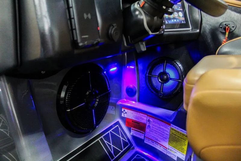 Slide: The Image of 2021 Tigé 25ZX boat interior with illuminated speakers and control panel. - 17