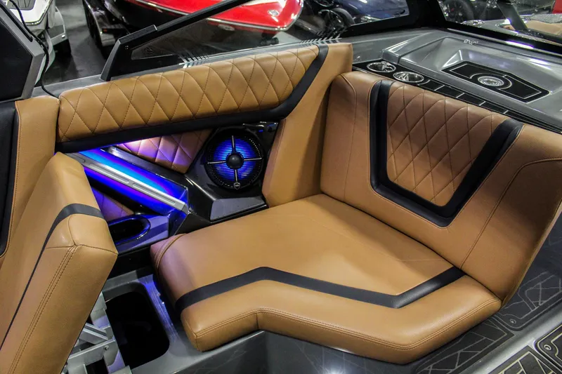 Slide: The Image of Luxurious interior of 2021 Tigé 25ZX boat with tan leather seating and ambient lighting. - 19