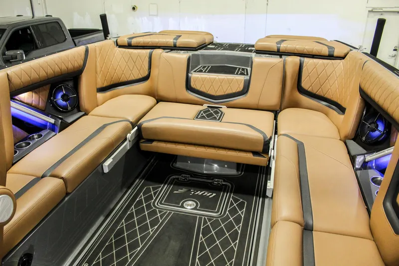 Slide: The Image of Luxurious interior of 2021 Tigé 25ZX boat with tan leather seating and ambient lighting. - 21