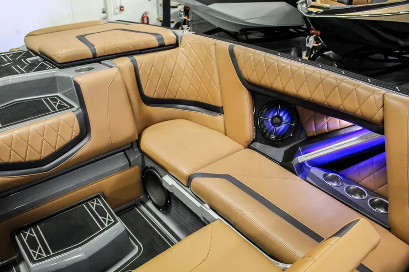 Slide: The Image of 2021 Tigé 25ZX boat interior with tan leather seats and blue LED lighting. - 22