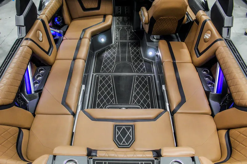 Slide: The Image of Luxurious interior of 2021 Tigé 25ZX boat with tan leather seating and ambient lighting. - 25