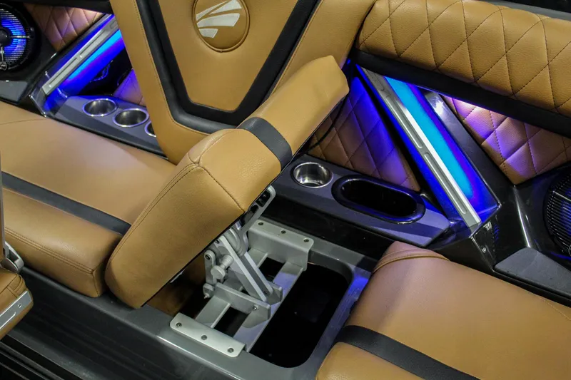 Slide: The Image of Luxurious interior of 2021 Tigé 25ZX boat with tan leather seats and blue LED lighting. - 26
