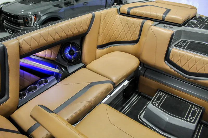 Slide: The Image of Luxurious interior of 2021 Tigé 25ZX boat with tan leather seating and ambient lighting. - 27