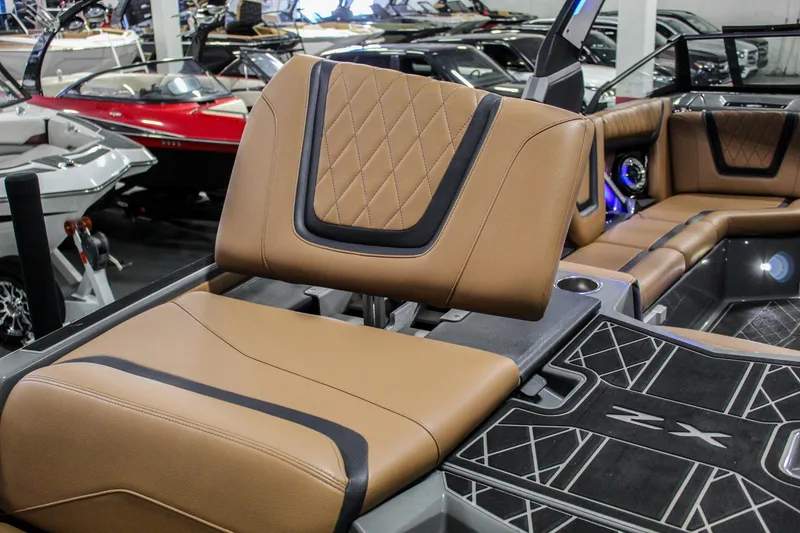 Slide: The Image of 2021 Tigé 25ZX boat interior with tan leather seating and modern design. - 30