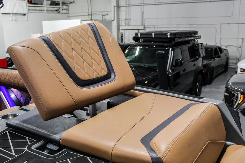 Slide: The Image of 2021 Tigé 25ZX boat interior with tan leather seating and black accents. - 31
