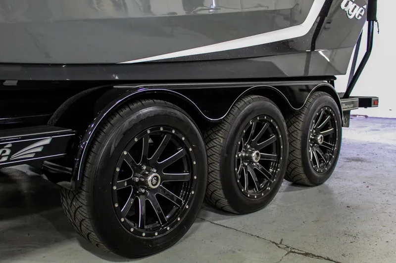 Slide: The Image of 2021 Tigé 25ZX boat trailer with sleek black wheels in a garage setting. - 38