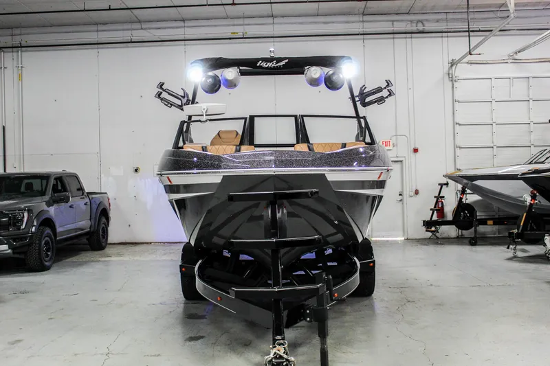 Slide: The Image of 2021 Tigé 25ZX boat in a garage, front view with trailer attached. - 4