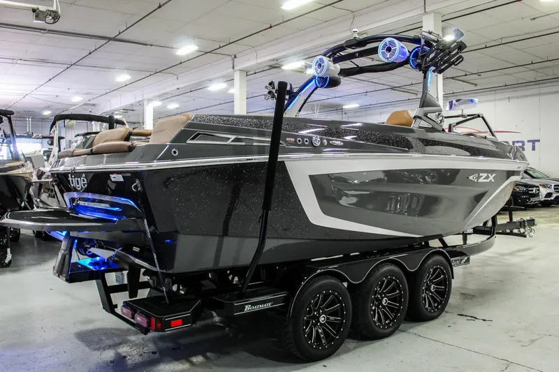 Slide: The Image of 2021 Tigé 25ZX boat in showroom, featuring sleek design and modern lighting. - 7