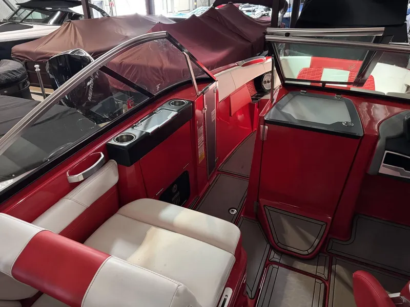 Slide: The Image of 2020 MasterCraft X26 boat interior with red and white seating and sleek design. - 8
