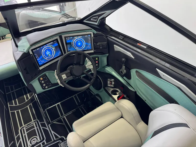 Slide: The Image of 2024 Centurion RI 245 boat interior with dual digital displays and modern steering wheel. - 25