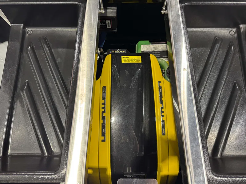 Slide: The Image of 2024 Centurion RI 245 engine compartment with yellow cover and storage bins. - 28