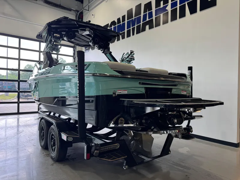 Slide: The Image of 2024 Centurion RI 245 boat on trailer in showroom, rear view. - 5