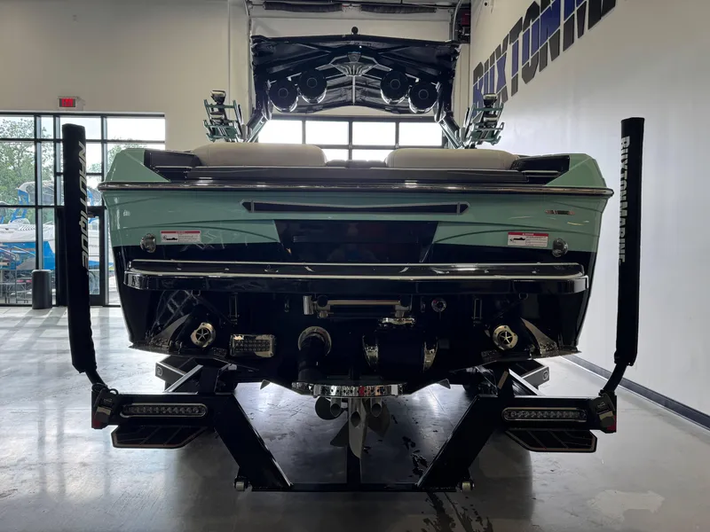 Slide: The Image of 2024 Centurion RI 245 boat rear view in showroom, showcasing sleek design and advanced features. - 6