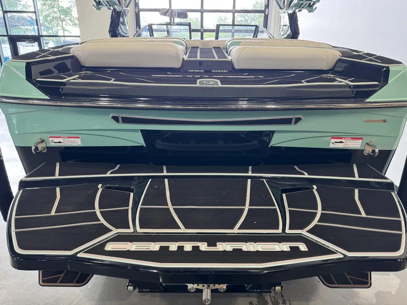 Slide: The Image of 2024 Centurion RI 245 boat rear view with sleek design and branding. - 8