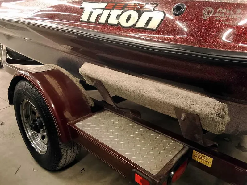 Slide: The Image of 2001 Triton TR186 sc boat trailer with maroon finish and carpeted step. - 10