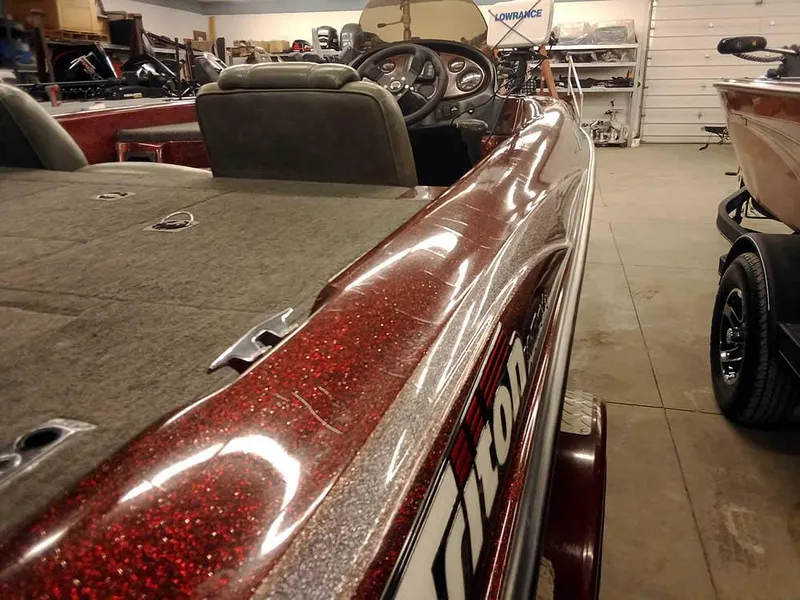 Slide: The Image of 2001 Triton TR186 SC boat in a garage, showcasing sleek design and glittery finish. - 11