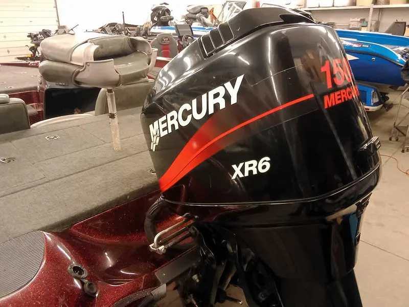 Slide: The Image of 2001 Triton TR186 sc boat with Mercury 150 XR6 outboard motor in a garage setting. - 2