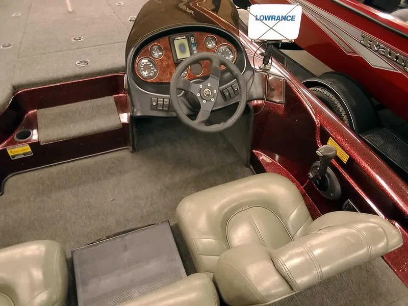 Slide: The Image of 2001 Triton TR186 sc boat interior with steering wheel and Lowrance equipment. - 22