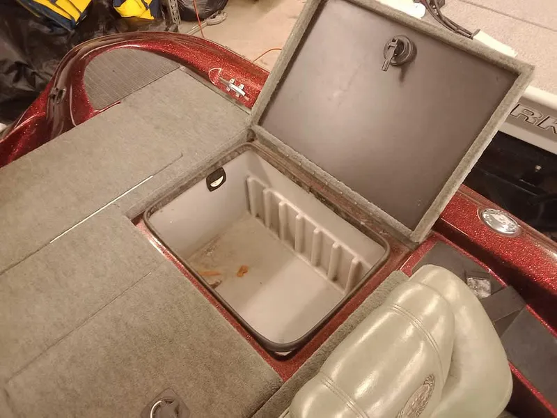 Slide: The Image of Open storage compartment in a 2001 Triton TR186 SC boat, featuring carpeted interior. - 28