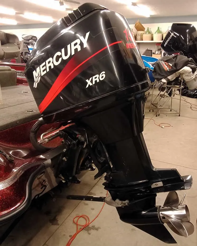 Slide: The Image of 2001 Triton TR186 sc with Mercury XR6 outboard motor in a garage setting. - 3