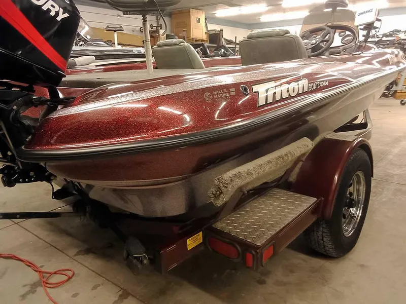 Slide: The Image of 2001 Triton TR186 SC boat with trailer in a garage setting. - 30