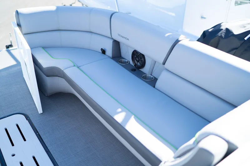 Slide: The Image of 2024 Veranda Vertex 25RL boat seating with cup holders and speaker, featuring sleek design. - 12