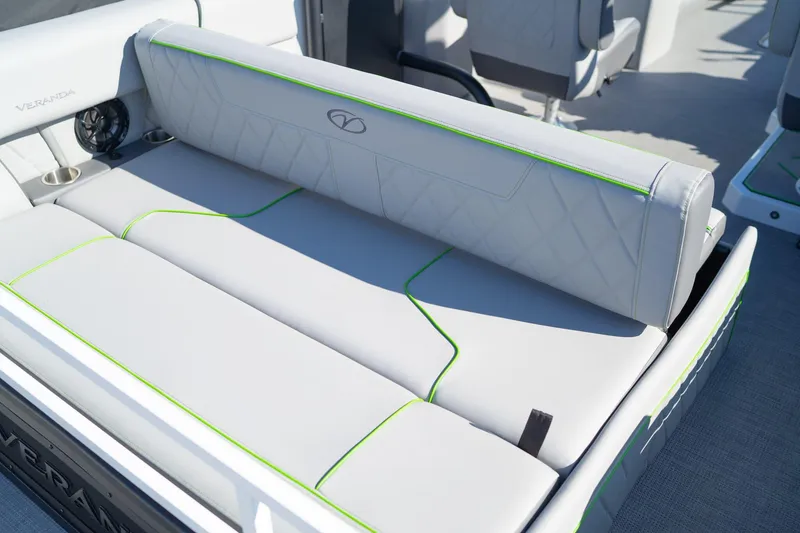 Slide: The Image of 2024 Veranda Vertex 25RL boat seating with green accents and cup holders. - 4