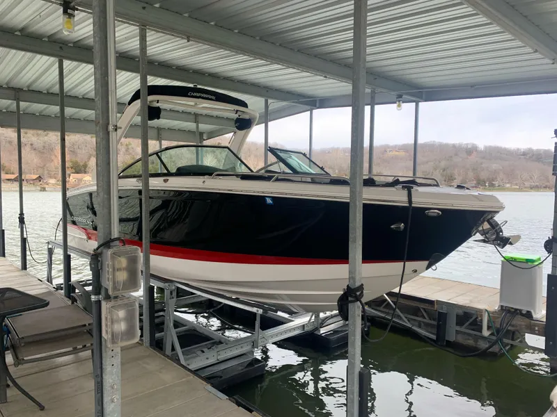 Slide: The Image of 2019 Chaparral 277 SSX boat docked on a lift in a covered marina. - 0