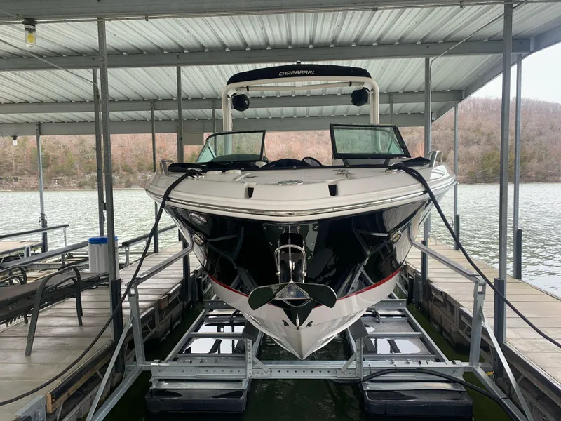 Slide: The Image of 2019 Chaparral 277 SSX boat docked under a covered marina. - 2