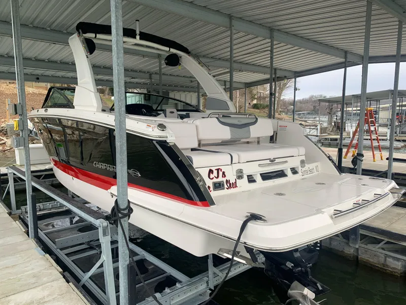 Slide: The Image of 2019 Chaparral 277 SSX boat docked in a covered marina. - 3