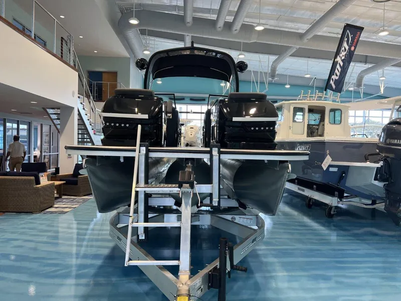 Slide: The Image of 2024 Veranda V One 25 boat displayed indoors on a trailer. - 1