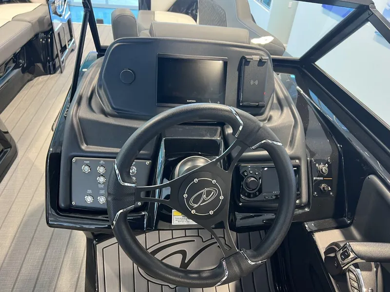 Slide: The Image of 2024 Veranda V One 25 boat dashboard with steering wheel and control panel. - 10