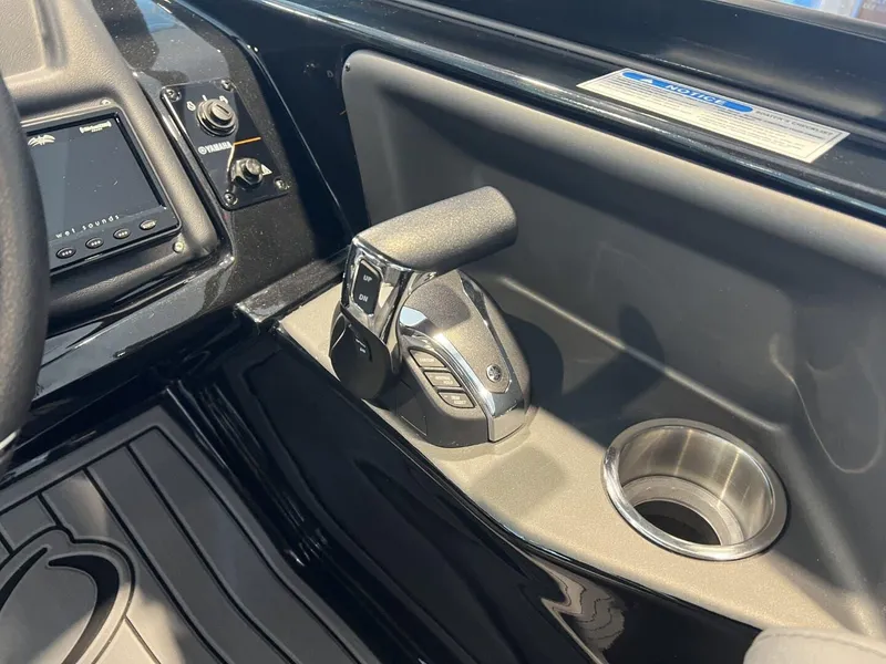 Slide: The Image of 2024 Veranda V One 25 boat control panel with throttle and cup holder. - 11