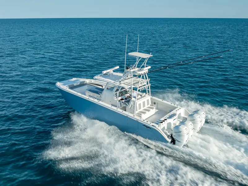 Slide: The Image of 2023 Invincible 37 Catamaran cruising on open ocean waters. - 13