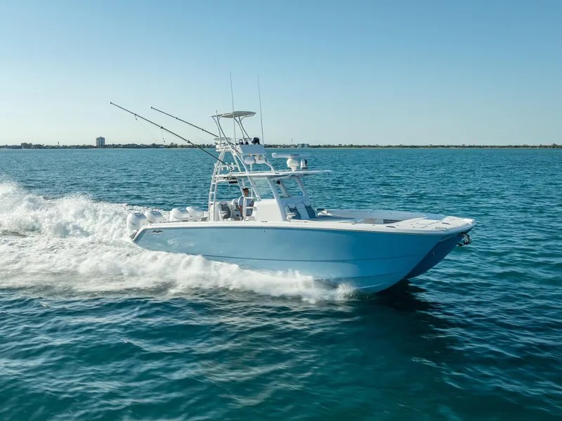 Slide: The Image of 2023 Invincible 37 Catamaran cruising on open water under clear blue sky. - 18