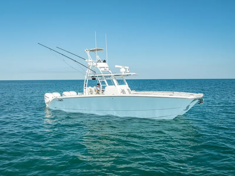 Slide: The Image of 2023 Invincible 37 Catamaran on open sea, clear sky, side view. - 2