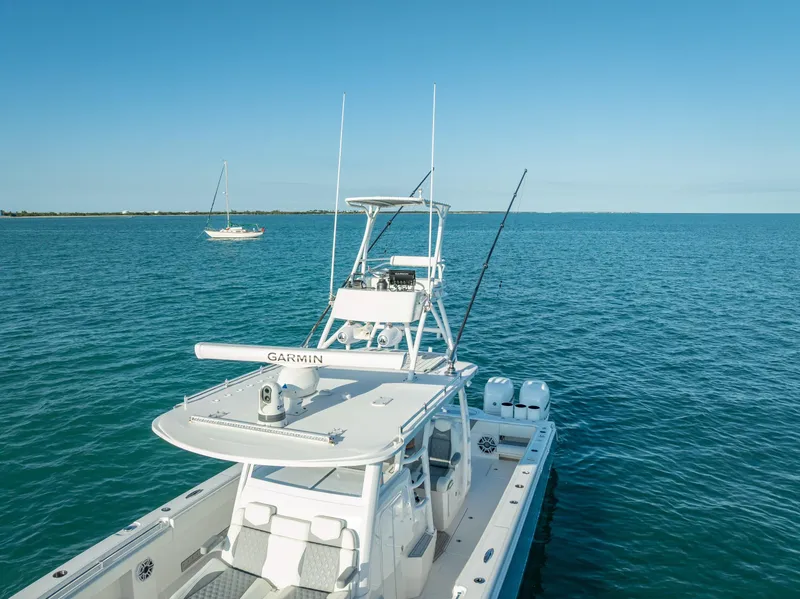 Slide: The Image of 2023 Invincible 37 Catamaran on open water, featuring advanced Garmin navigation. - 20